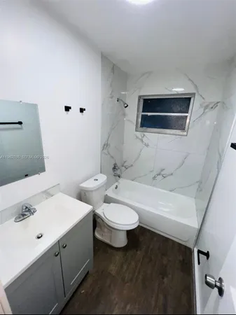 a bathroom with a double vanity sink toilet and mirror
