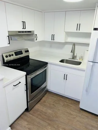 a kitchen with a sink and cabinets