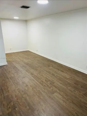an empty room with wooden floor