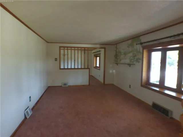 an empty room with a empty space and windows