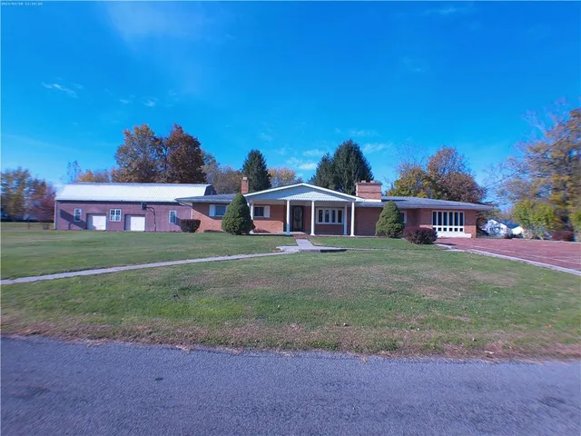 a front view of house with yard and seating area