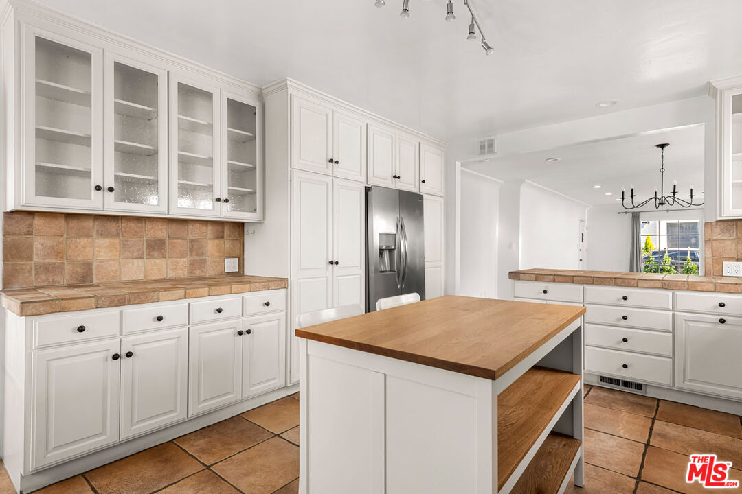 1849 Benecia Avenue Los Angeles, CA 90025 - Photo 12 of 59 a kitchen with granite countertop white cabinets and stainless steel appliances