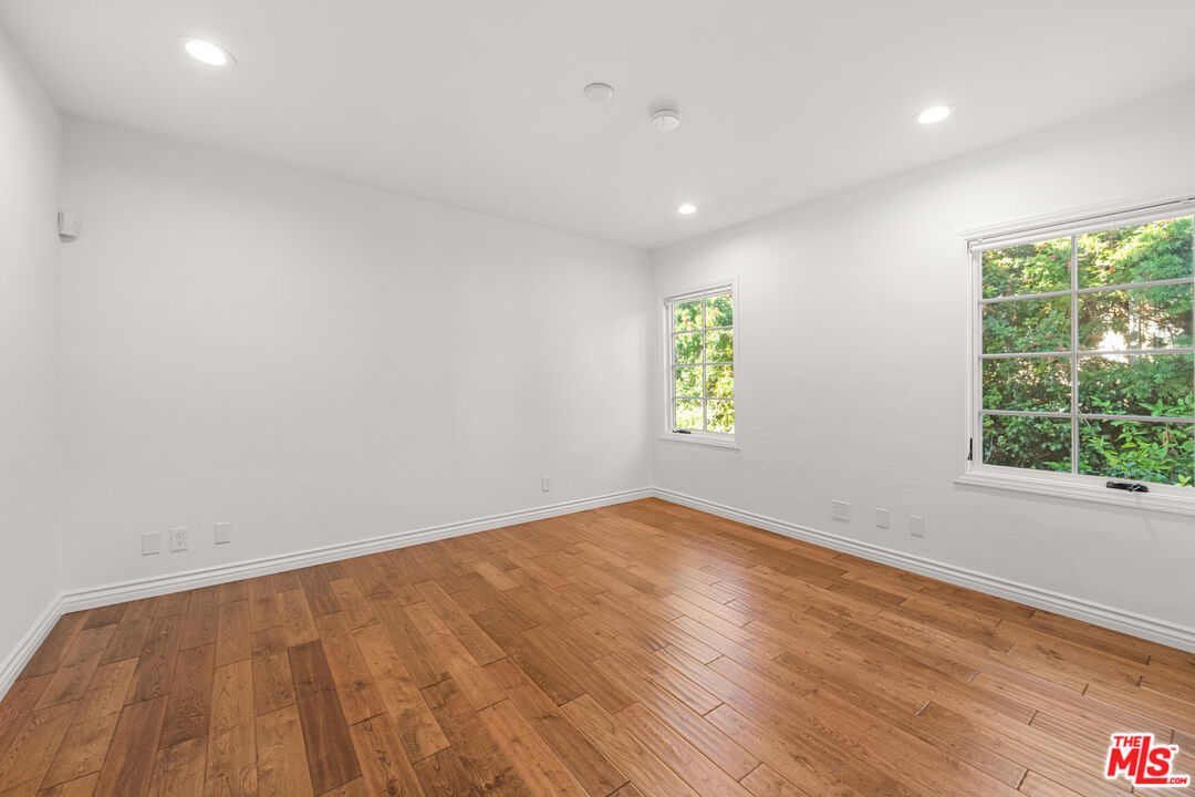 1849 Benecia Avenue Los Angeles, CA 90025 - Photo 16 of 59 an empty room with wooden floor and windows