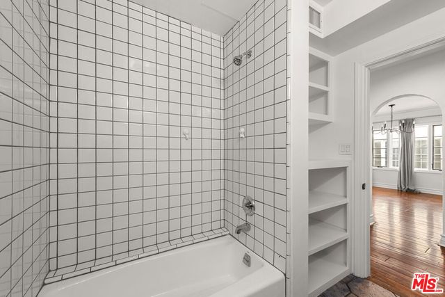 a view of a room with wooden floor and fan