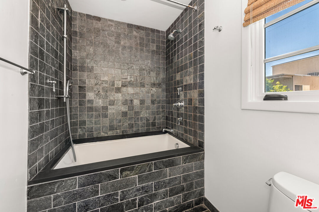 1849 Benecia Avenue Los Angeles, CA 90025 - Photo 28 of 59 a bathroom with a bathtub and a shower