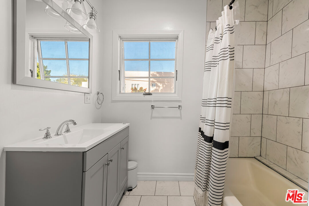 1849 Benecia Avenue Los Angeles, CA 90025 - Photo 37 of 59 a bathroom with a sink a toilet and window