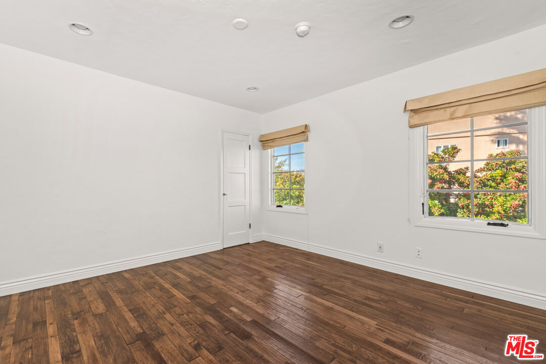1849 Benecia Avenue Los Angeles, CA 90025 - Photo 38 of 59 an empty room with wooden floor and windows