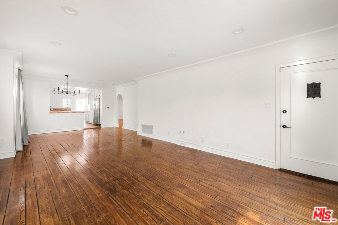 1849 Benecia Avenue Los Angeles, CA 90025 - Photo 4 of 59 an empty room with wooden floor & windows