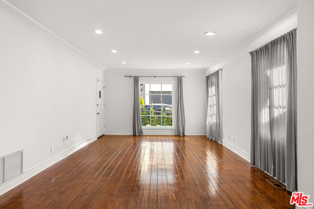 1849 Benecia Avenue Los Angeles, CA 90025 - Photo 5 of 59 a view of an empty room with wooden floor and a window