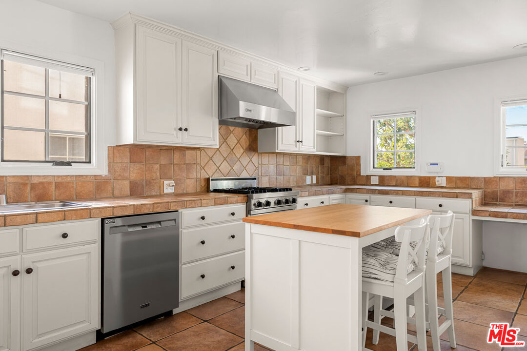 1849 Benecia Avenue Los Angeles, CA 90025 - Photo 8 of 59 a kitchen with cabinets appliances a sink and a window
