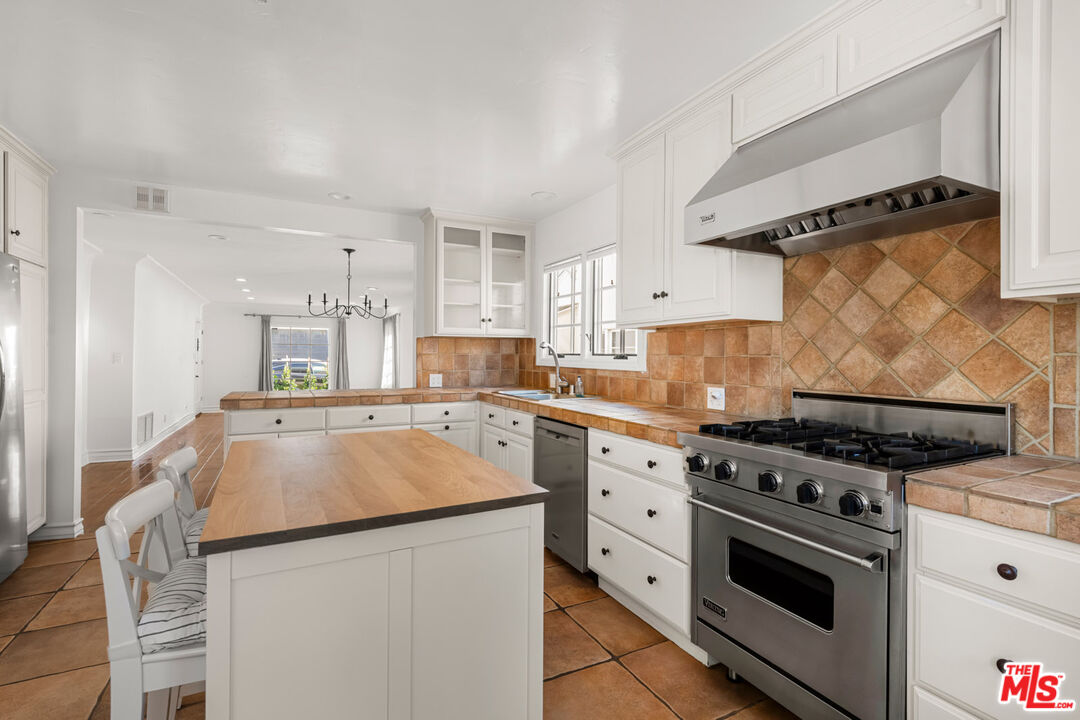 1849 Benecia Avenue Los Angeles, CA 90025 - Photo 10 of 59 a kitchen with granite countertop a sink and a stove top oven