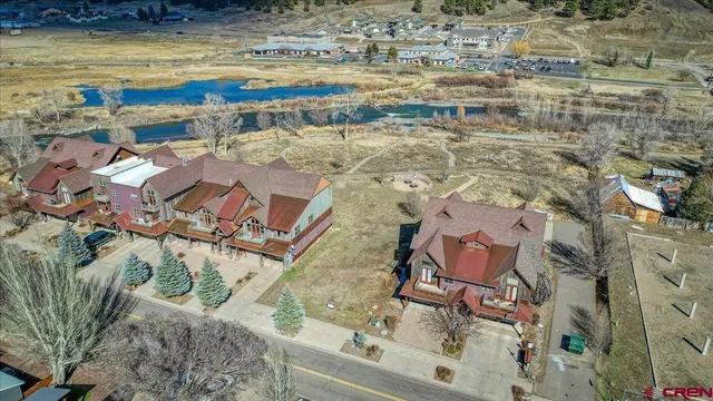 a view of swimming pool with seating area and lake view