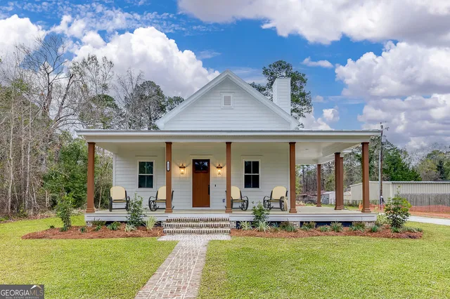 a view of a house with a backyard porch and sitting area