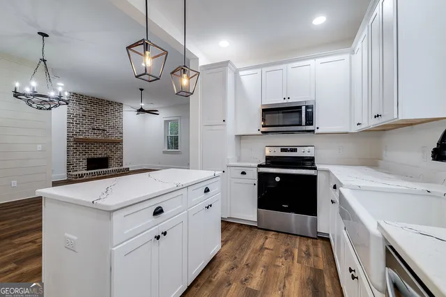 a kitchen with a stove oven and a sink