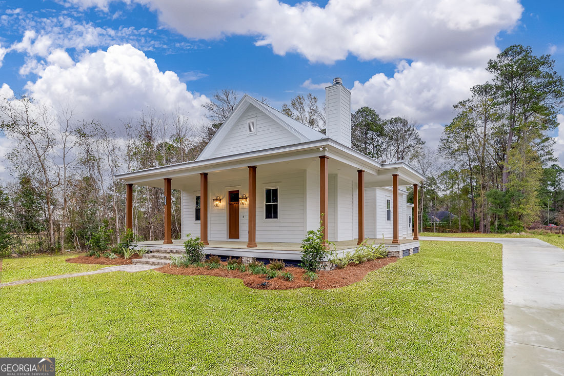 610 Rogers Street Pooler, GA 31322 - Photo 2 of 30 a front view of house with yard and trees