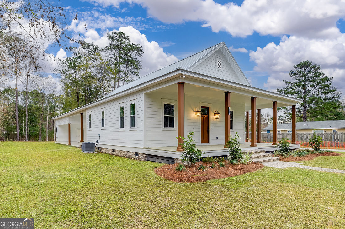 610 Rogers Street Pooler, GA 31322 - Photo 3 of 30 a front view of house with yard and trees around