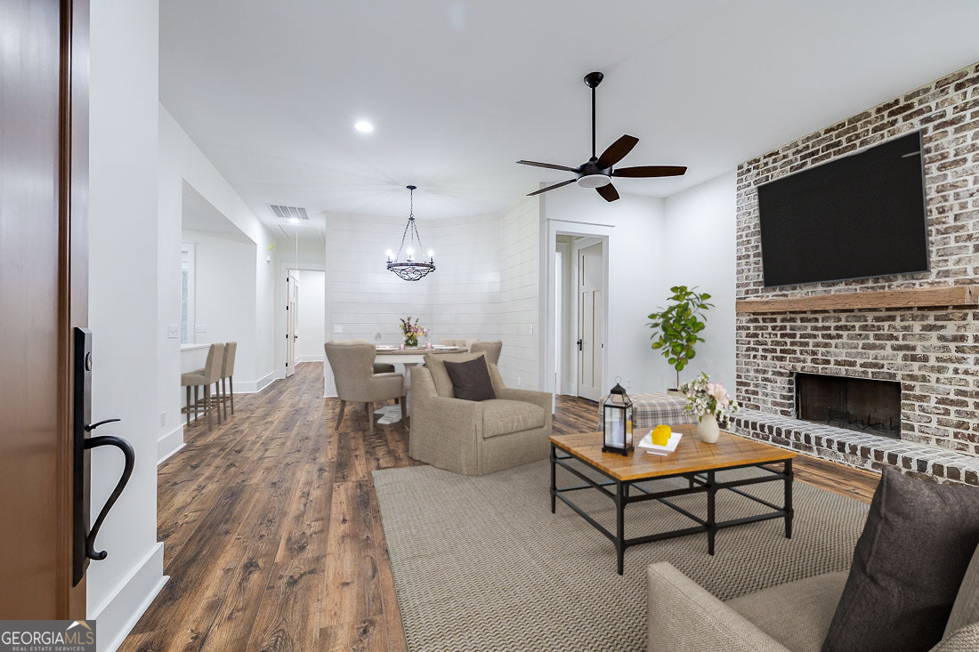610 Rogers Street Pooler, GA 31322 - Photo 6 of 30 a living room with furniture a flat screen tv and a fireplace