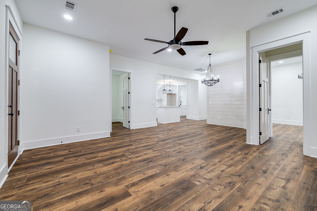 610 Rogers Street Pooler, GA 31322 - Photo 7 of 30 a view of a big room with wooden floor and a ceiling fan