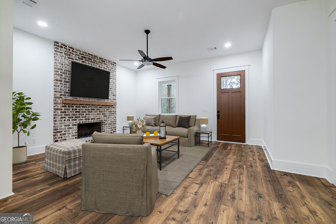 610 Rogers Street Pooler, GA 31322 - Photo 8 of 30 a living room with furniture and a fireplace