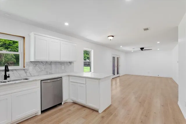 a kitchen with a sink cabinets and window