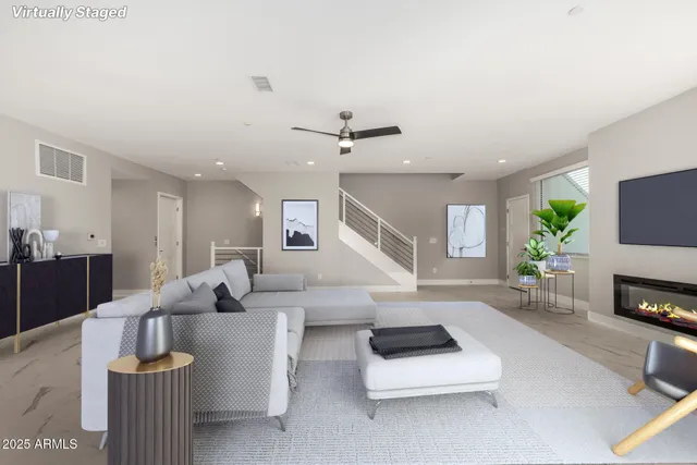 a living room with furniture and a fireplace