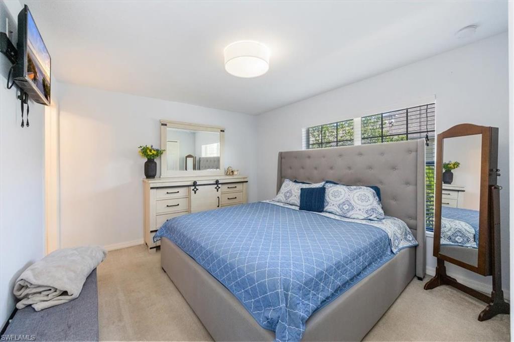 9072 Gervais Circle, Unit 307 Naples, FL 34120 - Photo 12 of 32 a bedroom with a bed and a window