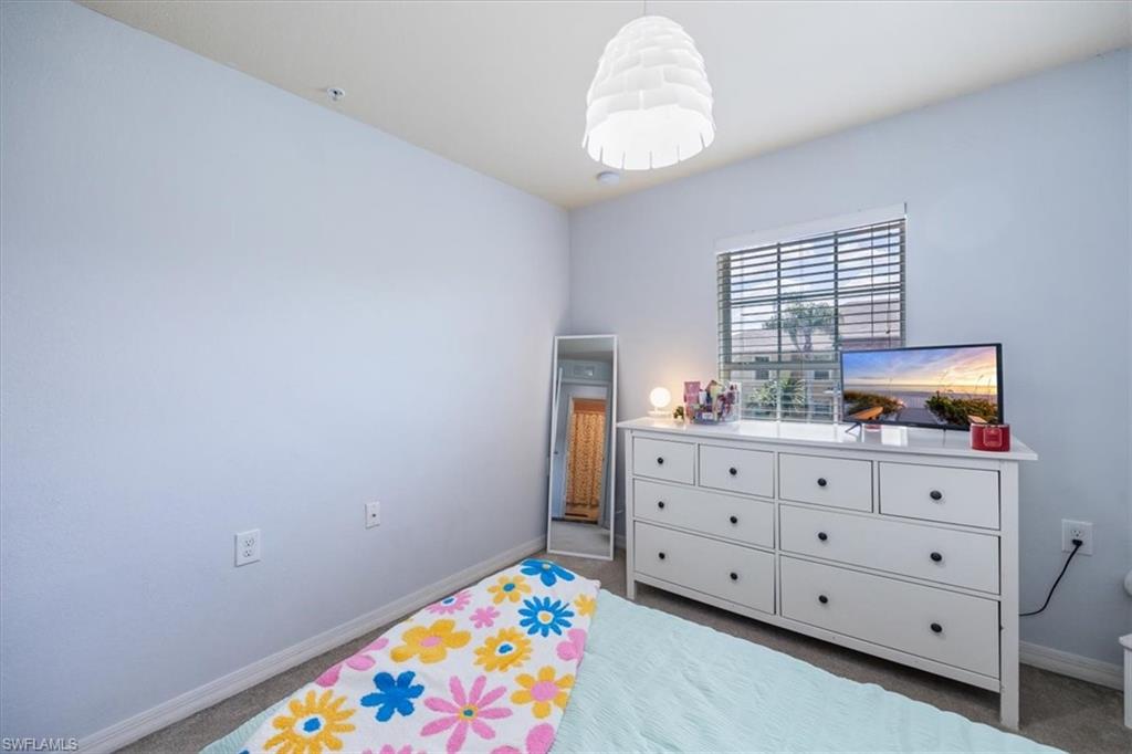9072 Gervais Circle, Unit 307 Naples, FL 34120 - Photo 15 of 32 a room with toys and dresser