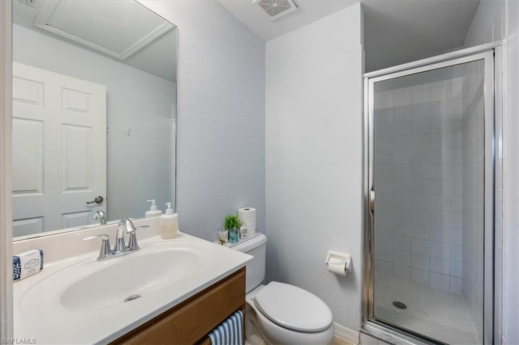 9072 Gervais Circle, Unit 307 Naples, FL 34120 - Photo 20 of 32 a bathroom with a sink toilet and shower