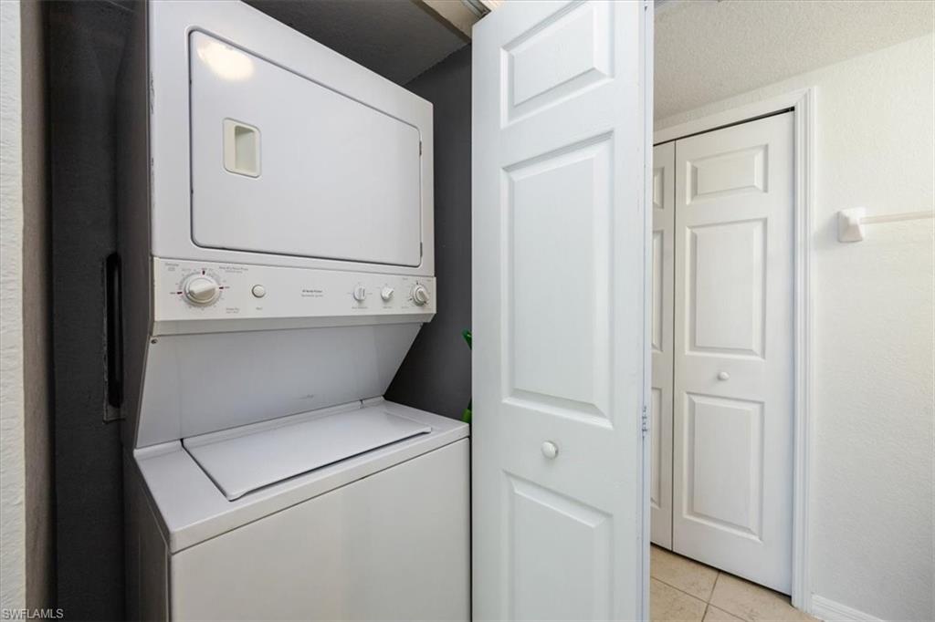 9072 Gervais Circle, Unit 307 Naples, FL 34120 - Photo 21 of 32 a view of bathroom with a washer and dryer