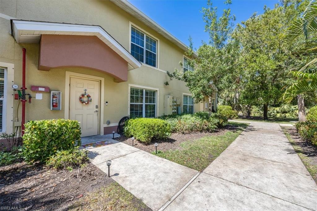 9072 Gervais Circle, Unit 307 Naples, FL 34120 - Photo 23 of 32 a front view of a house with garden