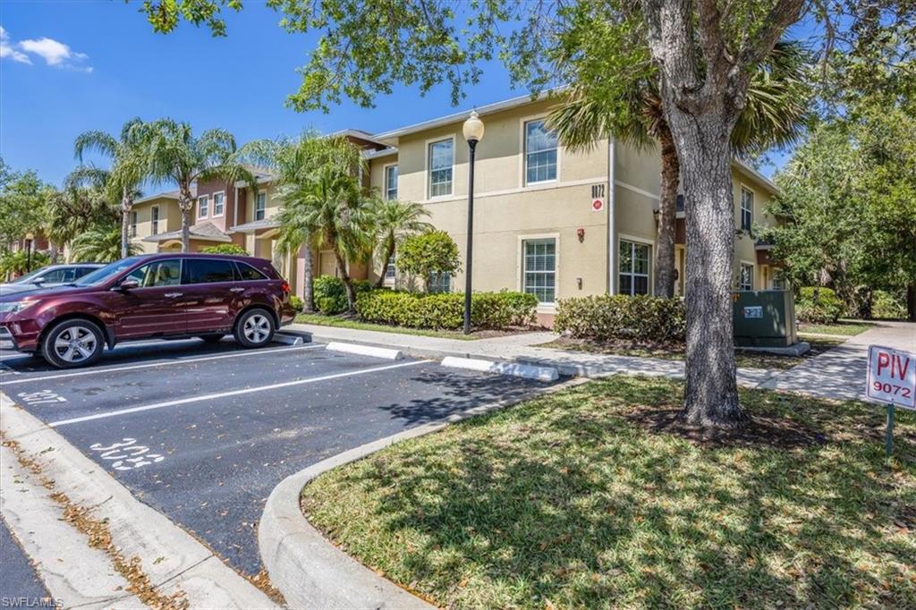 9072 Gervais Circle, Unit 307 Naples, FL 34120 - Photo 24 of 32 a view of a car park in front of a house