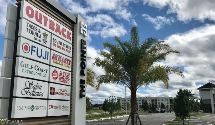 9072 Gervais Circle, Unit 307 Naples, FL 34120 - Photo 29 of 32 a sign that is on a pole on a street