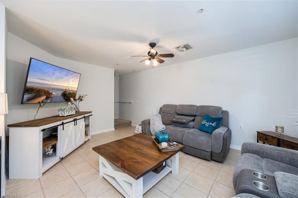 9072 Gervais Circle, Unit 307 Naples, FL 34120 - Photo 3 of 32 a living room with furniture and a flat screen tv