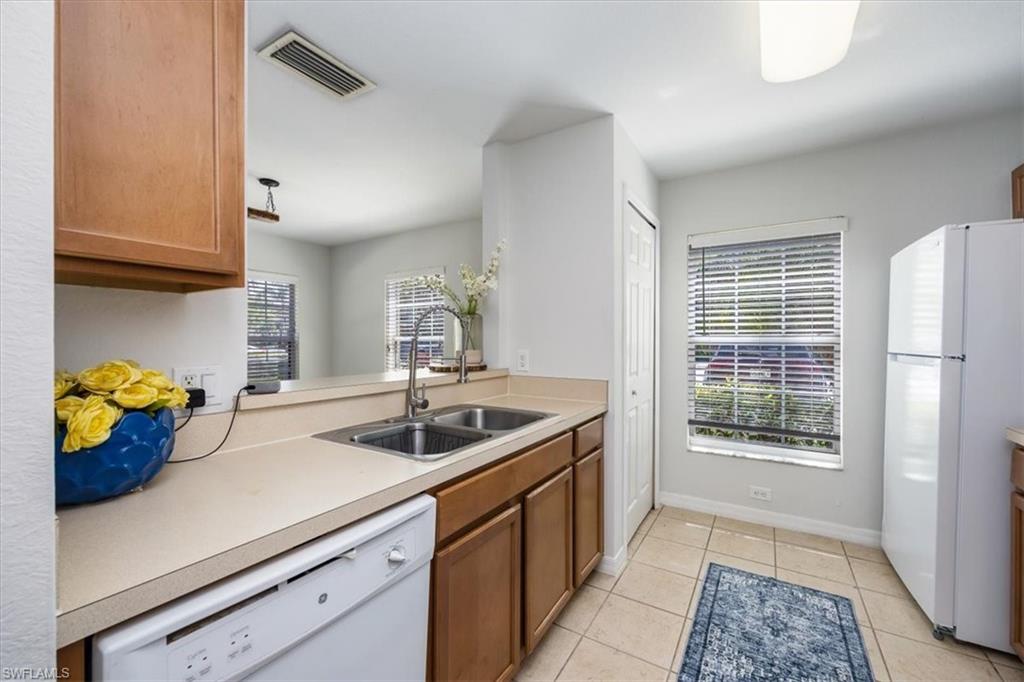 9072 Gervais Circle, Unit 307 Naples, FL 34120 - Photo 9 of 32 a kitchen with a sink and a window