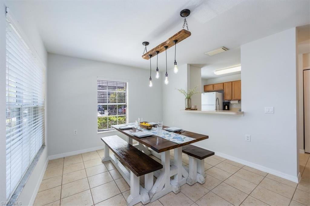 9072 Gervais Circle, Unit 307 Naples, FL 34120 - Photo 10 of 32 a dining room with table and chairs