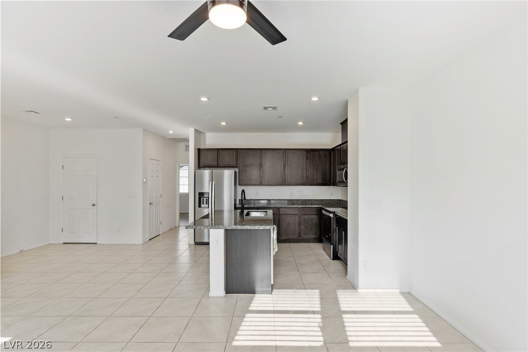 6227 Runestone Street Las Vegas, NV 89113 - Photo 33 of 33 This spacious kitchen and living area features an open floor plan and ample counter space.