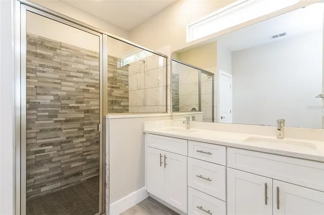 a bathroom with a double vanity sink and a mirror