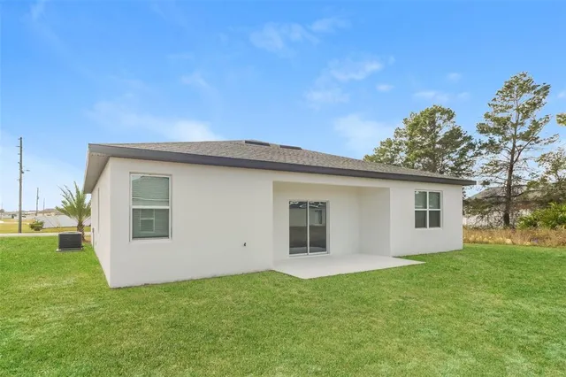 a view of a house with a backyard
