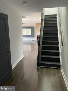 6907 Jones View Drive, Unit 3C Baltimore, MD 21209 - Photo 3 of 14 a view of a room with stairs and wooden floor