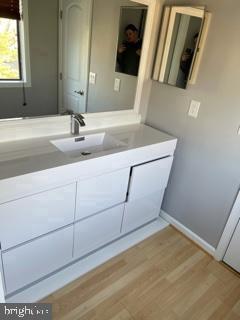 6907 Jones View Drive, Unit 3C Baltimore, MD 21209 - Photo 5 of 14 a bathroom with a sink and a mirror
