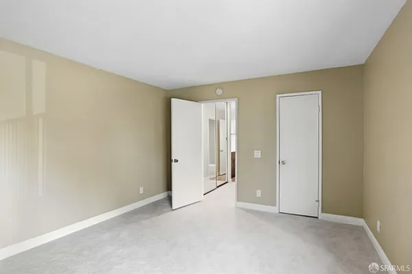 a view of an empty room and closet area