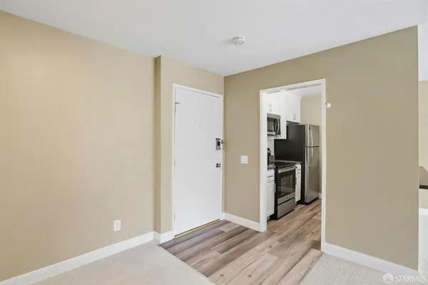a view of hallway with wooden floor