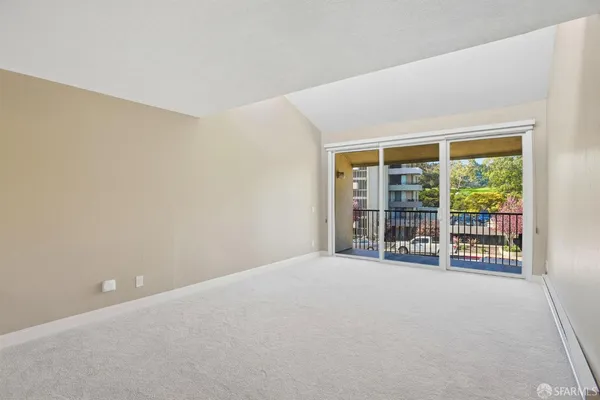 an empty room with floor to ceiling window