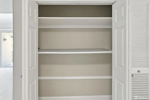 a kitchen with kitchen island a refrigerator a stove a microwave and island