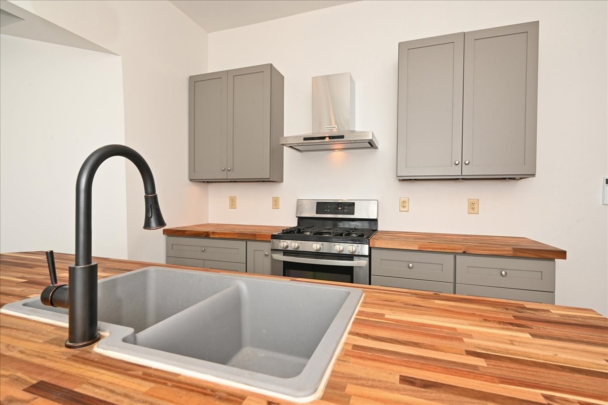 426 Sherman Street Southeast Decatur, AL 35601 - Photo 14 of 41 a kitchen with stainless steel appliances granite countertop a stove and a white cabinets