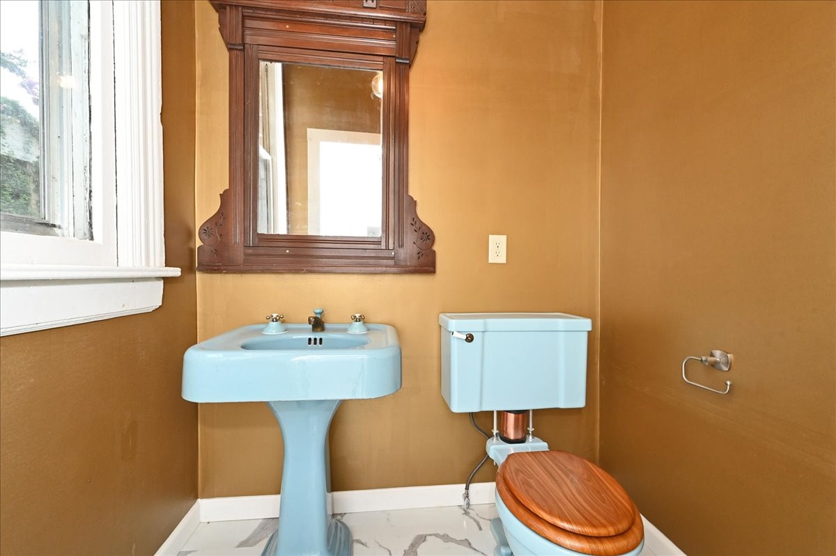 426 Sherman Street Southeast Decatur, AL 35601 - Photo 18 of 41 a bathroom with a sink a toilet and a mirror