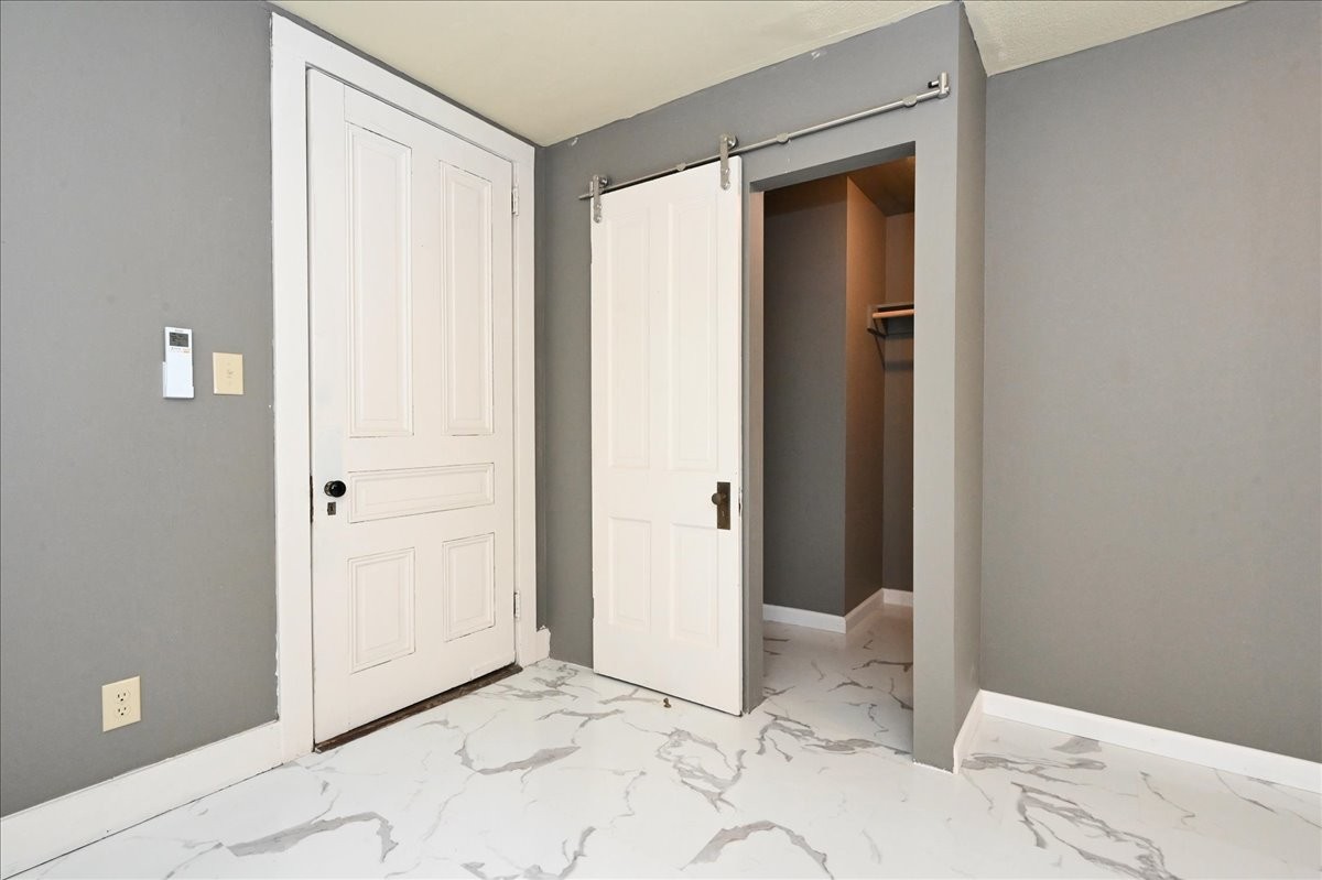 426 Sherman Street Southeast Decatur, AL 35601 - Photo 20 of 41 a view of a bedroom with wooden floor and bathroom