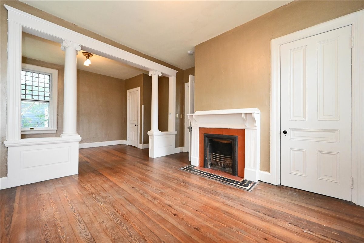 426 Sherman Street Southeast Decatur, AL 35601 - Photo 25 of 41 an empty room with wooden floor fireplace and windows