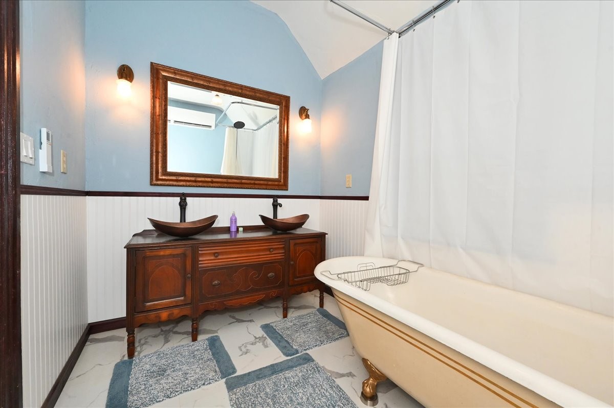 426 Sherman Street Southeast Decatur, AL 35601 - Photo 30 of 41 a bathroom with a tub sink and mirror