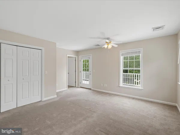 a view of white house with a yard and potted plants